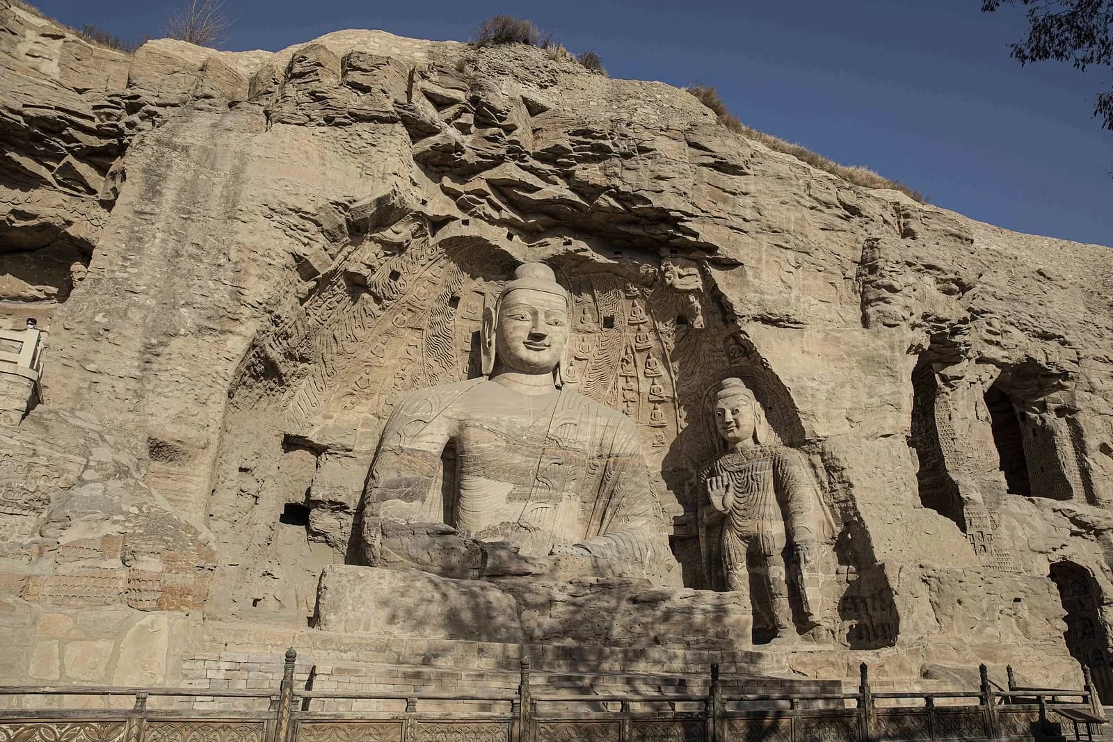Monumental Northern Wei Buddhist sculpture carved into the sandstone cliff face at Yungang Grottoes, Datong